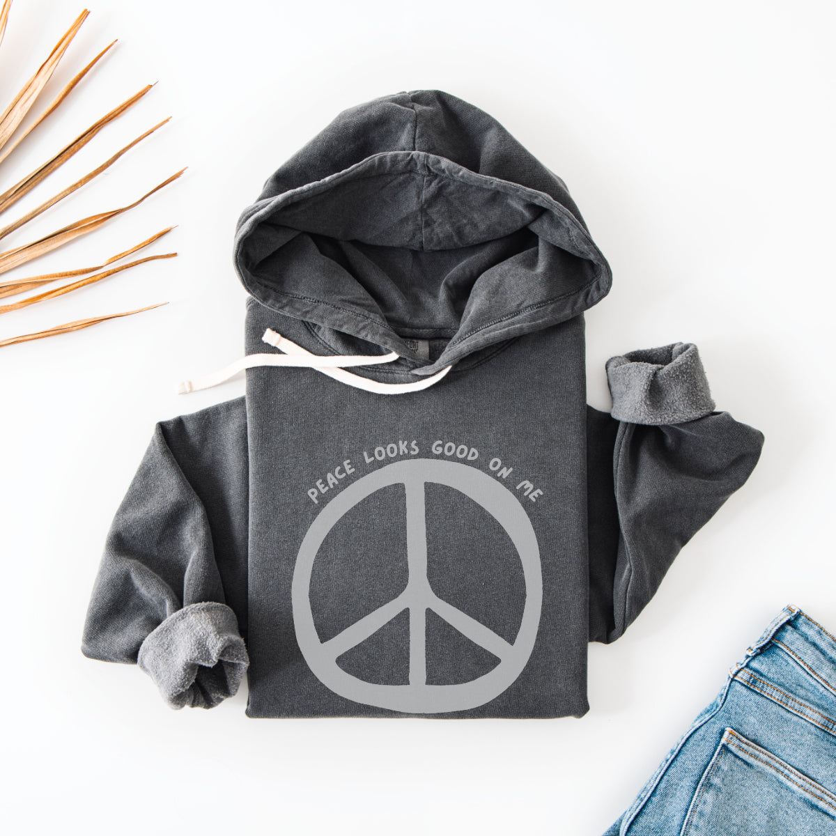 Black hoodie with bold white peace sign and text Peace Looks Good On Me